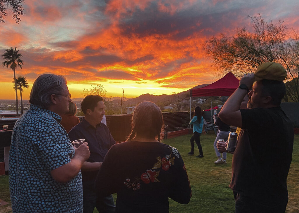 photo of sunset with party goers. 