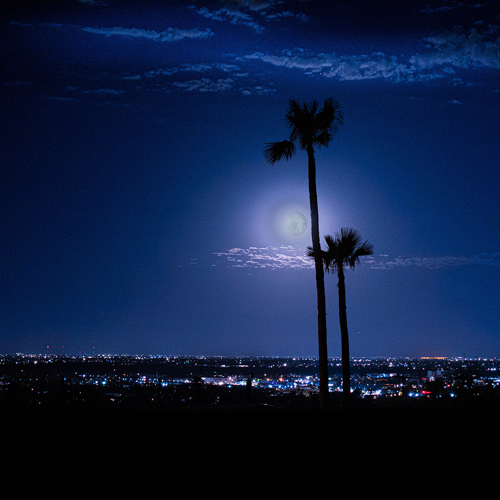 Photo of full moon overlooking Phoenix. 